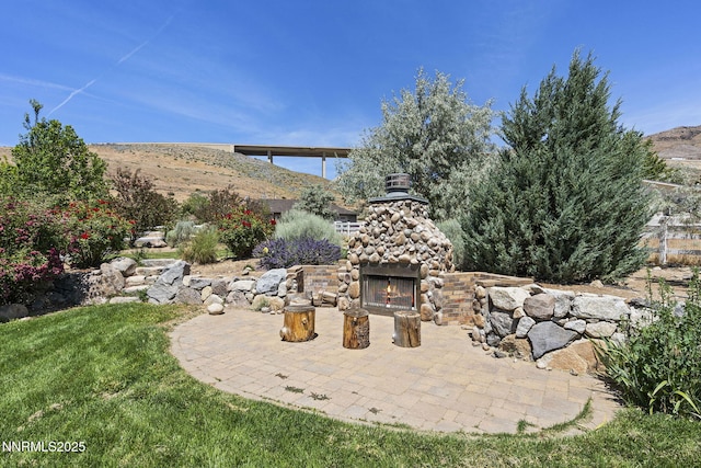 5 Connie Way, Reno, NV 89521 - view of patio / terrace with an outdoor stone fireplace and a mountain view