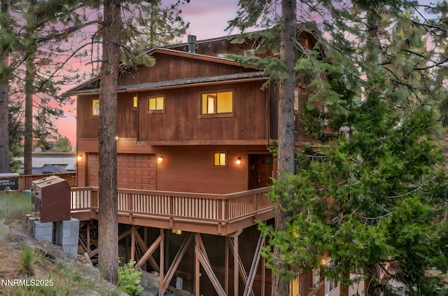 638 N Martin Dr, Zephyr Cove, NV 89448 - back of property at dusk featuring a wooden deck
