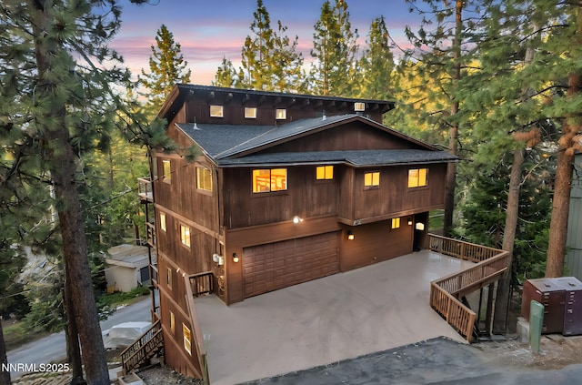 638 N Martin Dr, Zephyr Cove, NV 89448 - chalet / cabin featuring stairway, concrete driveway, roof with shingles, and a garage