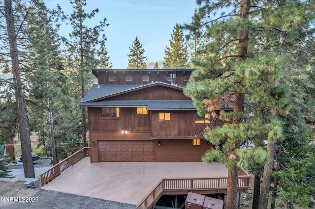 638 N Martin Dr, Zephyr Cove, NV 89448 - back of house with a shingled roof, a garage, and concrete driveway