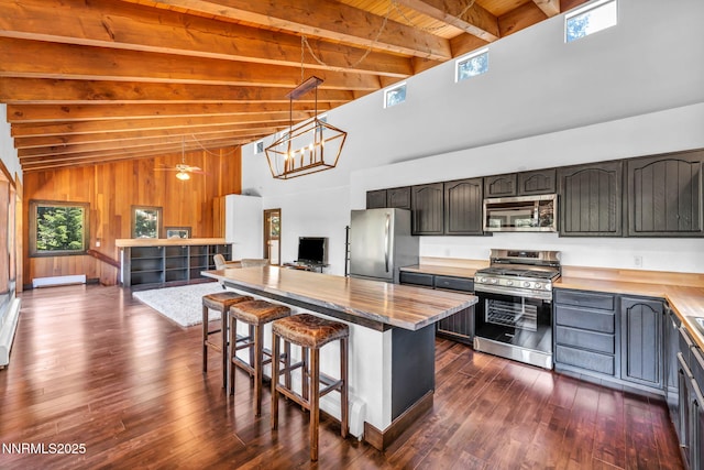 638 N Martin Dr, Zephyr Cove, NV 89448 - kitchen with appliances with stainless steel finishes, high vaulted ceiling, a breakfast bar, a wooden ceiling with exposed beams, and dark wood finished floors