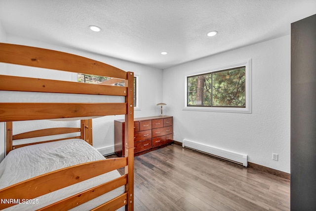 638 N Martin Dr, Zephyr Cove, NV 89448 - bedroom featuring a baseboard heating unit, a textured ceiling, wood finished floors, and recessed lighting