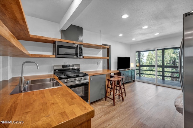 638 N Martin Dr, Zephyr Cove, NV 89448 - kitchen featuring stainless steel appliances, butcher block countertops, open shelves, a textured ceiling, and recessed lighting