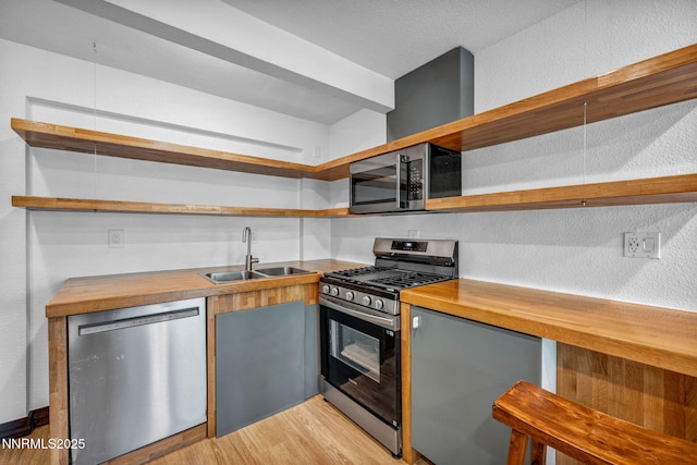 638 N Martin Dr, Zephyr Cove, NV 89448 - kitchen with open shelves, stainless steel appliances, wood counters, light wood-style floors, and a textured wall