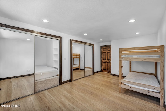 638 N Martin Dr, Zephyr Cove, NV 89448 - unfurnished bedroom with multiple closets, light wood-type flooring, and recessed lighting