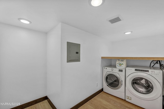 638 N Martin Dr, Zephyr Cove, NV 89448 - laundry room with electric panel, washing machine and dryer, and light wood finished floors