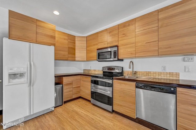 638 N Martin Dr, Zephyr Cove, NV 89448 - kitchen featuring appliances with stainless steel finishes, light wood-style floors, dark countertops, and recessed lighting