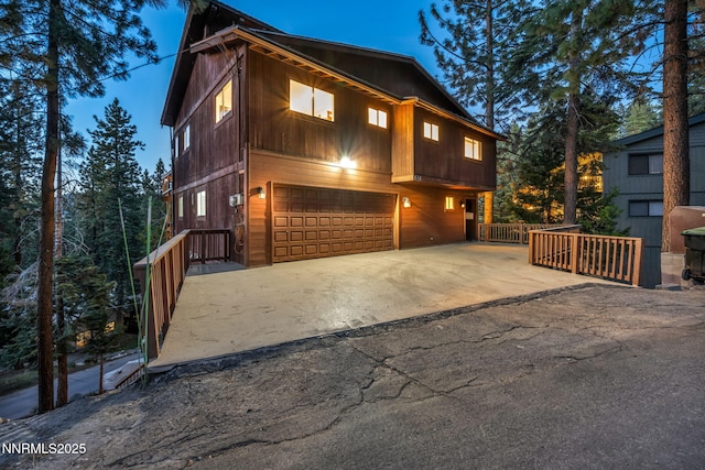 638 N Martin Dr, Zephyr Cove, NV 89448 - rustic home with an attached garage and concrete driveway