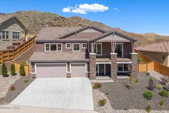 435 Gooseberry Dr, Reno, NV 89523 - view of front facade with stone siding, a balcony, concrete driveway, and an attached garage
