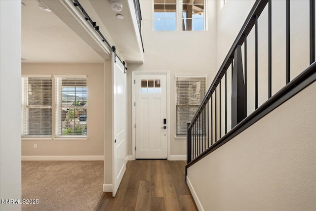435 Gooseberry Dr, Reno, NV 89523 - foyer entrance featuring a barn door, stairs, and wood finished floors