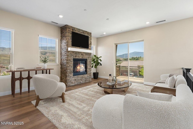 435 Gooseberry Dr, Reno, NV 89523 - living room featuring wood finished floors, healthy amount of natural light, a stone fireplace, and recessed lighting