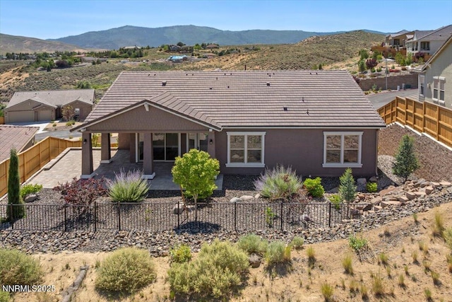 435 Gooseberry Dr, Reno, NV 89523 - rear view of house featuring a patio, a tile roof, a fenced backyard, and a mountain view