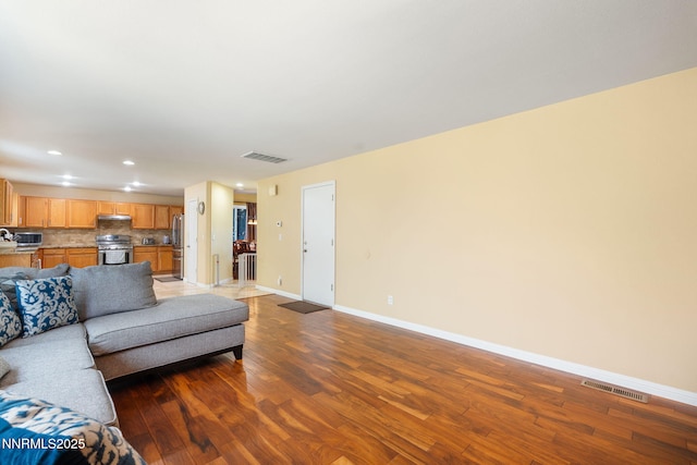 5455 Montego Ct, Reno, NV 89523 - living area featuring dark wood-style flooring and recessed lighting