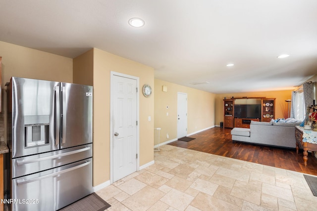 5455 Montego Ct, Reno, NV 89523 - kitchen with stainless steel fridge with ice dispenser, recessed lighting, and stone tile floors