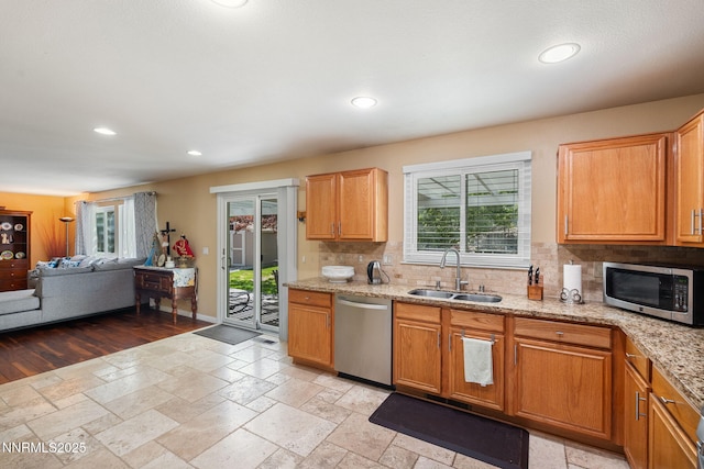 5455 Montego Ct, Reno, NV 89523 - kitchen with appliances with stainless steel finishes, tasteful backsplash, recessed lighting, light stone countertops, and stone tile flooring