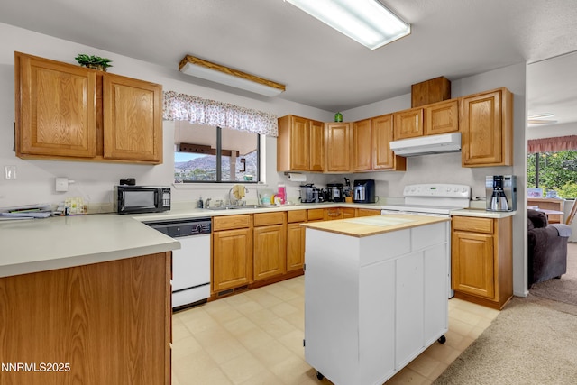 2855 Wilcox Ranch Rd, Reno, NV 89510 - kitchen with white appliances, under cabinet range hood, light floors, light countertops, and a kitchen island