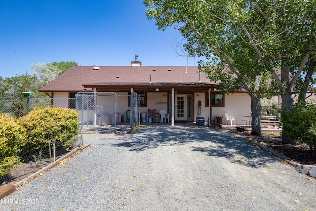 2855 Wilcox Ranch Rd, Reno, NV 89510 - back of house featuring a patio area, a chimney, and a gate