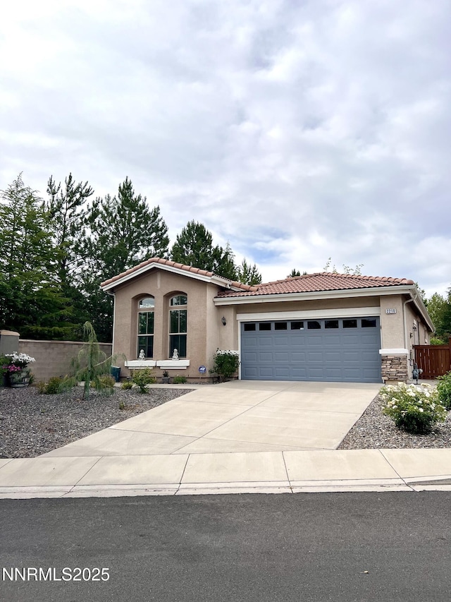 2210 Meritage Dr, Sparks, NV 89434 - view of front of home featuring driveway, stucco siding, a tile roof, and a garage