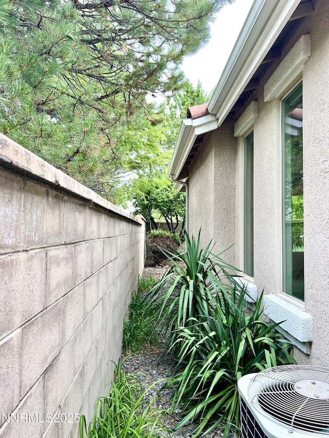 2210 Meritage Dr, Sparks, NV 89434 - view of side of property with stucco siding and a central air condition unit