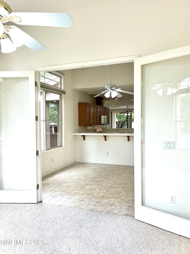 2210 Meritage Dr, Sparks, NV 89434 - unfurnished living room with a ceiling fan, healthy amount of natural light, and dark aggregate flooring