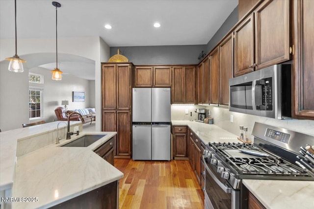 3215 Epic Ave, Reno, NV 89512 - kitchen featuring stainless steel appliances, light wood finished floors, pendant lighting, light stone counters, and recessed lighting