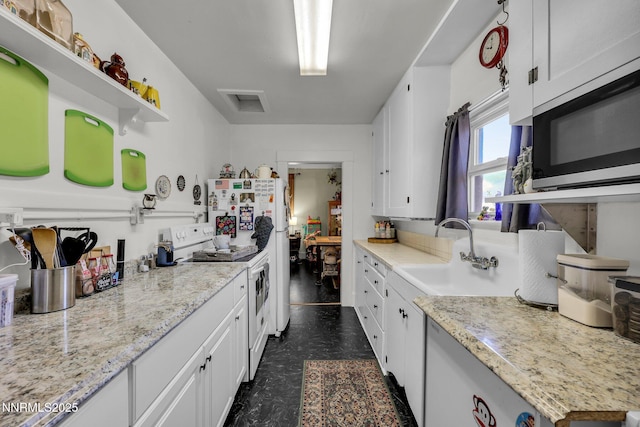 1236 Victorian Plaza Cir, Sparks, NV 89431 - kitchen featuring white appliances, white cabinets, dark flooring, and open shelves
