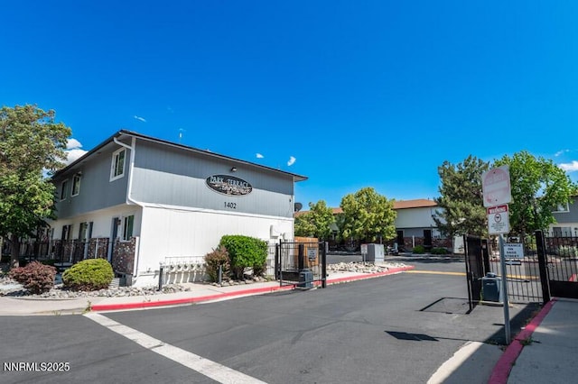 1412 E 9th St Unit 7, Reno, NV 89512 - view of asphalt street featuring curbs, a gated entry, and traffic signs