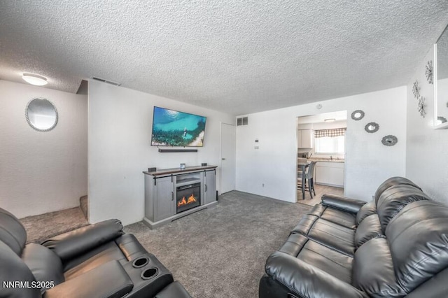 1412 E 9th St Unit 7, Reno, NV 89512 - living room featuring a textured ceiling, a glass covered fireplace, and carpet flooring