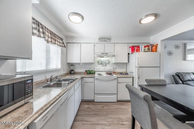 1412 E 9th St Unit 7, Reno, NV 89512 - kitchen with white appliances, light countertops, healthy amount of natural light, and white cabinetry