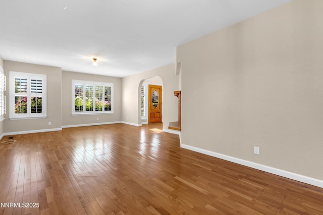979 University Ridge Dr, Reno, NV 89512 - empty room with arched walkways and wood-type flooring