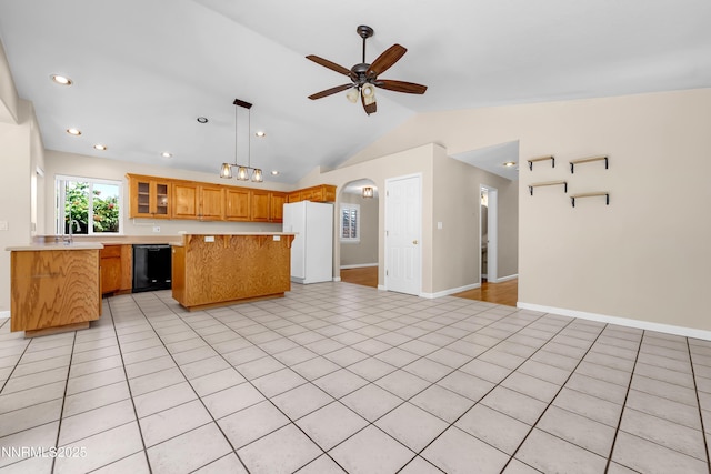 979 University Ridge Dr, Reno, NV 89512 - kitchen featuring freestanding refrigerator, black dishwasher, lofted ceiling, light countertops, and open floor plan