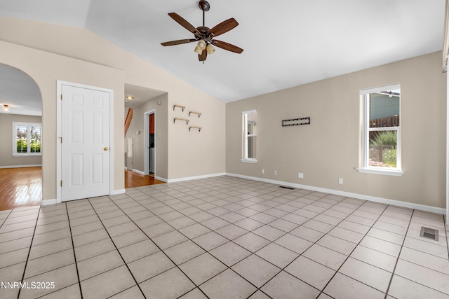 979 University Ridge Dr, Reno, NV 89512 - spare room featuring ceiling fan, arched walkways, vaulted ceiling, and light tile patterned floors