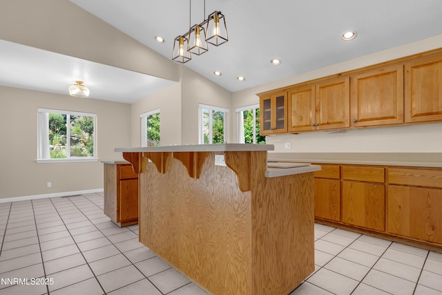 979 University Ridge Dr, Reno, NV 89512 - kitchen featuring a breakfast bar, recessed lighting, light countertops, light tile patterned flooring, and a center island