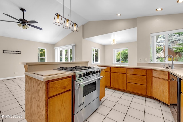979 University Ridge Dr, Reno, NV 89512 - kitchen featuring high end stove, light tile patterned flooring, lofted ceiling, a ceiling fan, and light countertops