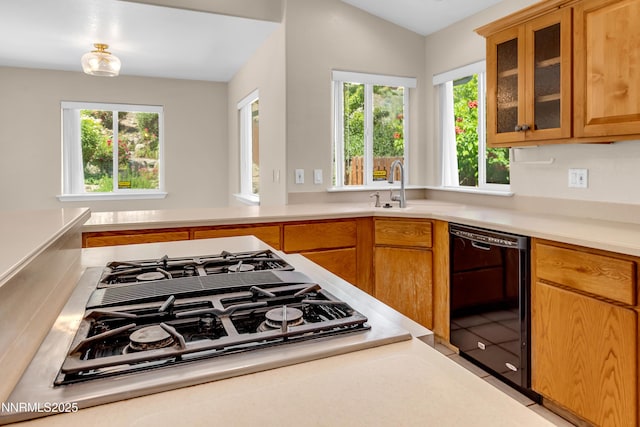 979 University Ridge Dr, Reno, NV 89512 - kitchen featuring black appliances, light countertops, glass insert cabinets, and brown cabinets