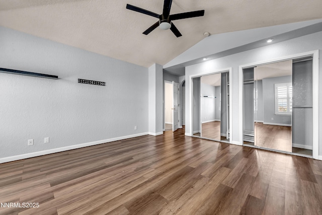 979 University Ridge Dr, Reno, NV 89512 - unfurnished bedroom with vaulted ceiling, two closets, wood finished floors, and ceiling fan