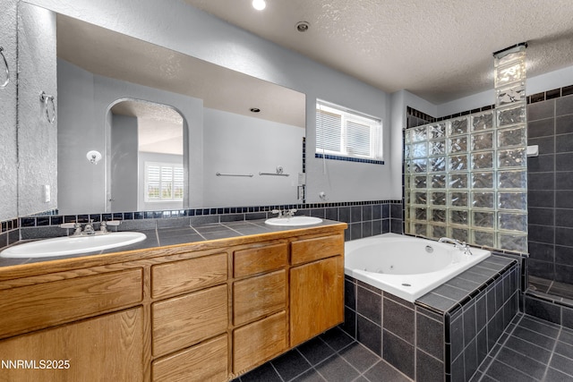 979 University Ridge Dr, Reno, NV 89512 - full bathroom featuring a walk in shower, double vanity, a jetted tub, tile patterned floors, and a textured ceiling