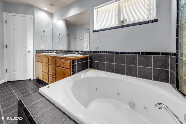 979 University Ridge Dr, Reno, NV 89512 - full bath featuring a textured wall, a jetted tub, double vanity, and tile patterned flooring