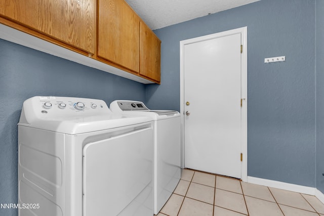 979 University Ridge Dr, Reno, NV 89512 - laundry room featuring cabinet space, separate washer and dryer, and light tile patterned flooring