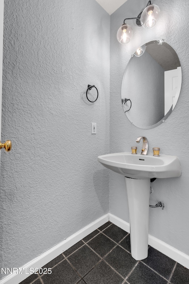 979 University Ridge Dr, Reno, NV 89512 - bathroom featuring baseboards and a sink