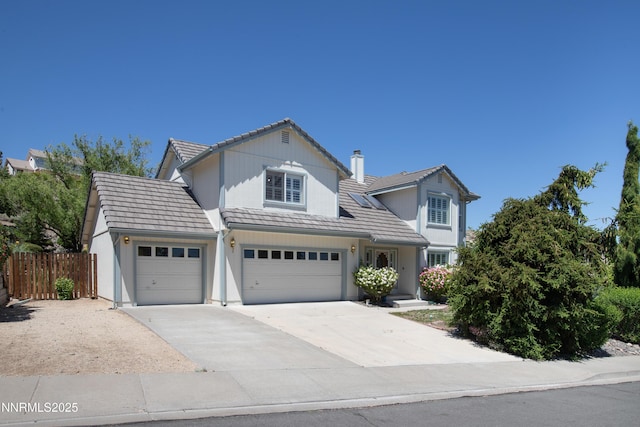 979 University Ridge Dr, Reno, NV 89512 - traditional-style house featuring a tile roof, driveway, and a garage