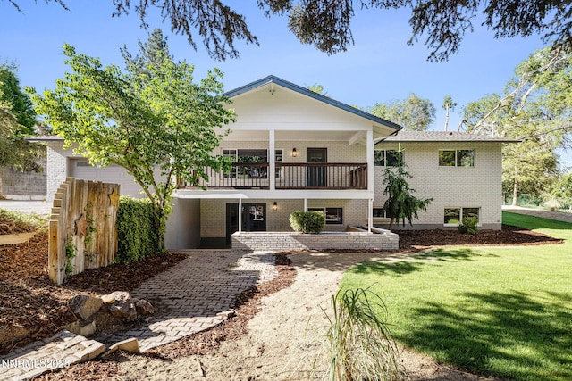50 Moore Ln, Reno, NV 89509 - view of front of house with a balcony, a front lawn, and brick siding
