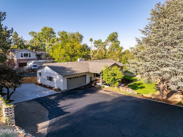 50 Moore Ln, Reno, NV 89509 - view of front of property featuring a garage, driveway, roof with shingles, and a chimney