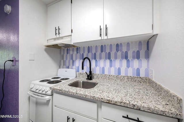 2450 Lymbery St Unit 233, Reno, NV 89509 - kitchen featuring white range with electric stovetop, under cabinet range hood, white cabinetry, light stone countertops, and backsplash