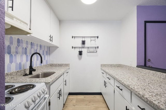2450 Lymbery St Unit 233, Reno, NV 89509 - kitchen featuring white electric range oven, light wood-style floors, white cabinetry, light stone countertops, and exhaust hood