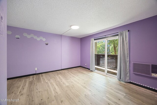 2450 Lymbery St Unit 233, Reno, NV 89509 - spare room with wood finished floors, a textured ceiling, and a wall mounted AC