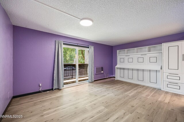 2450 Lymbery St Unit 233, Reno, NV 89509 - empty room with wood finished floors, an AC wall unit, and a textured ceiling
