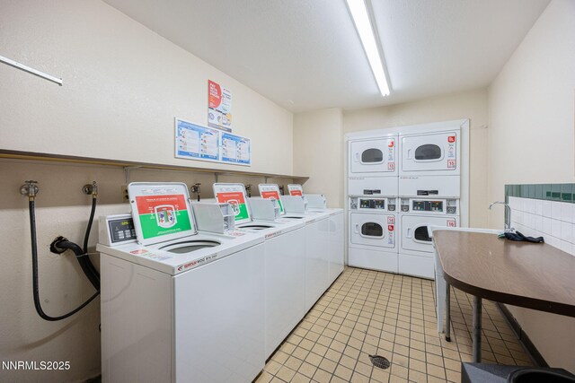 2450 Lymbery St Unit 233, Reno, NV 89509 - community laundry with estacked washer and dryer, independent washer and dryer, and light tile patterned flooring