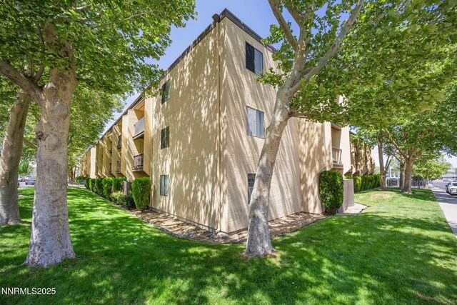 2450 Lymbery St Unit 233, Reno, NV 89509 - view of side of property featuring stucco siding and a lawn