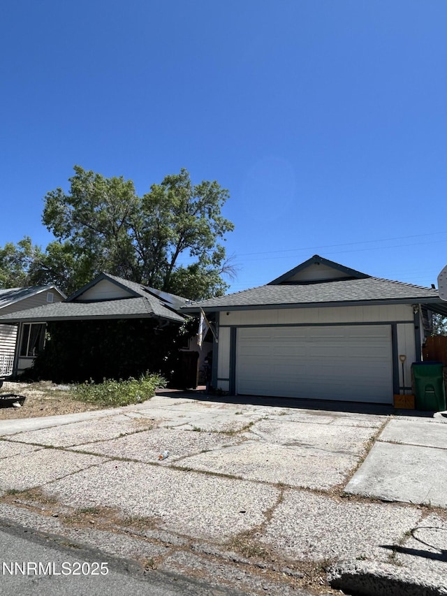 1655 Byrd Dr, Sparks, NV 89431 - view of front of house featuring a garage, driveway, and roof with shingles